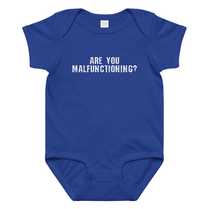 "Are you malfunctioning?" printed on a royal baby jersey bodysuit laying on a flat surface amongst other clothes