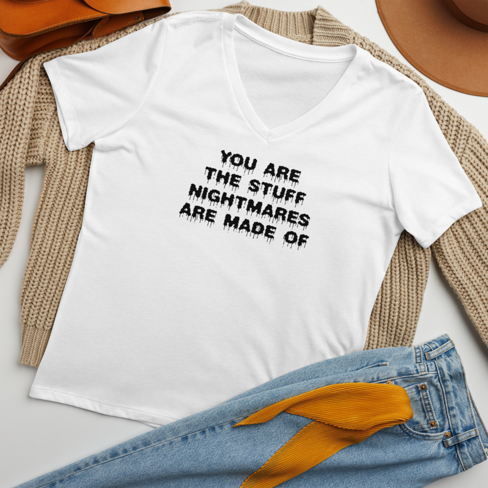 "You are the stuff nightmares are made of" printed on a solid white blend women's relaxed v-neck t-shirt laying on a flat surface amongst other clothes