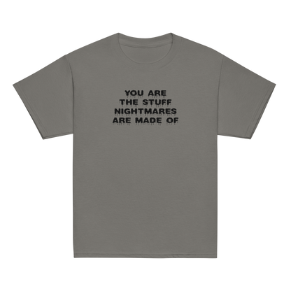 "You are the stuff nightmares are made of" printed on a charcoal youth classic tee laying on a flat surface