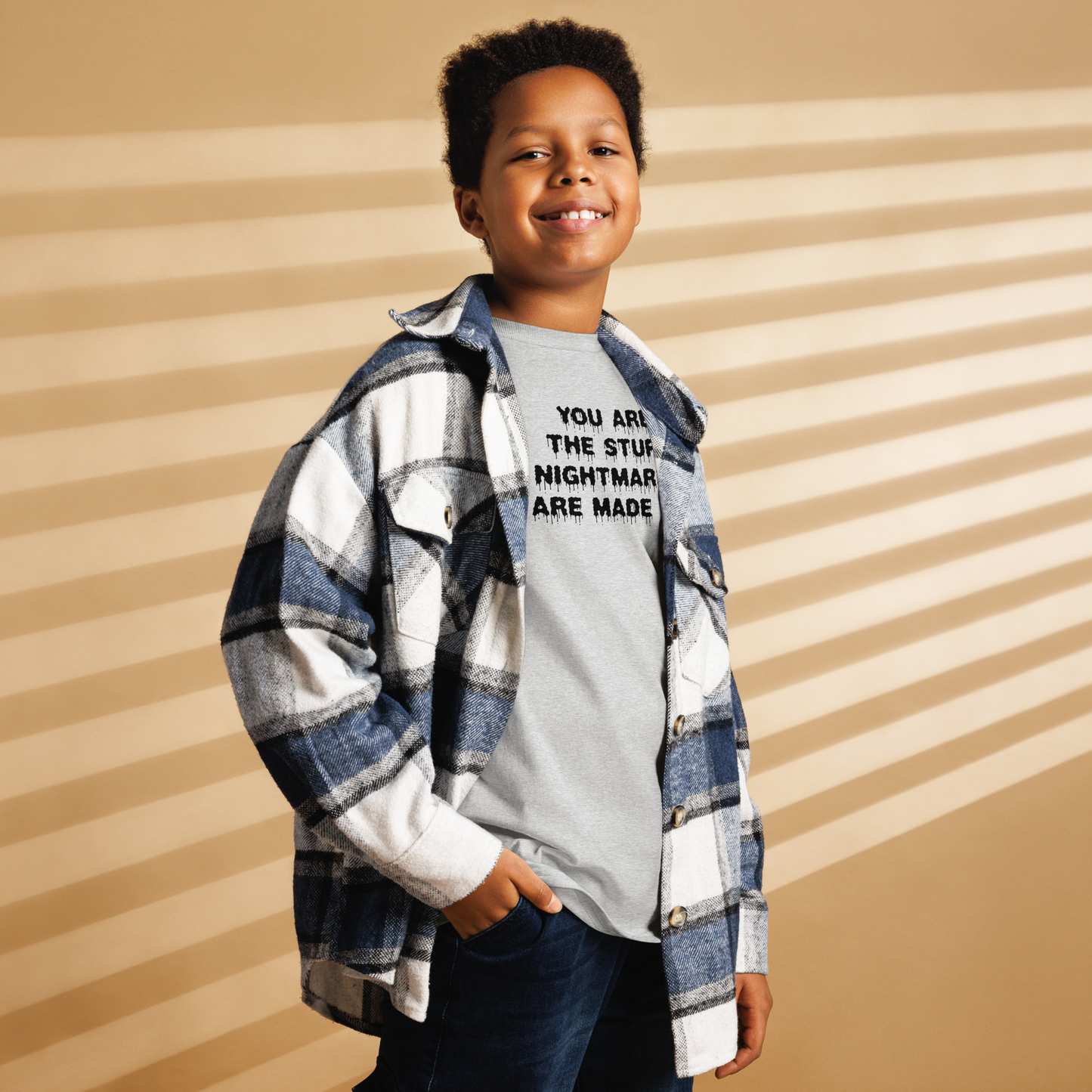 "You are the stuff nightmares are made of" printed on a sport grey youth classic tee worn by a male also wearing a jacket
