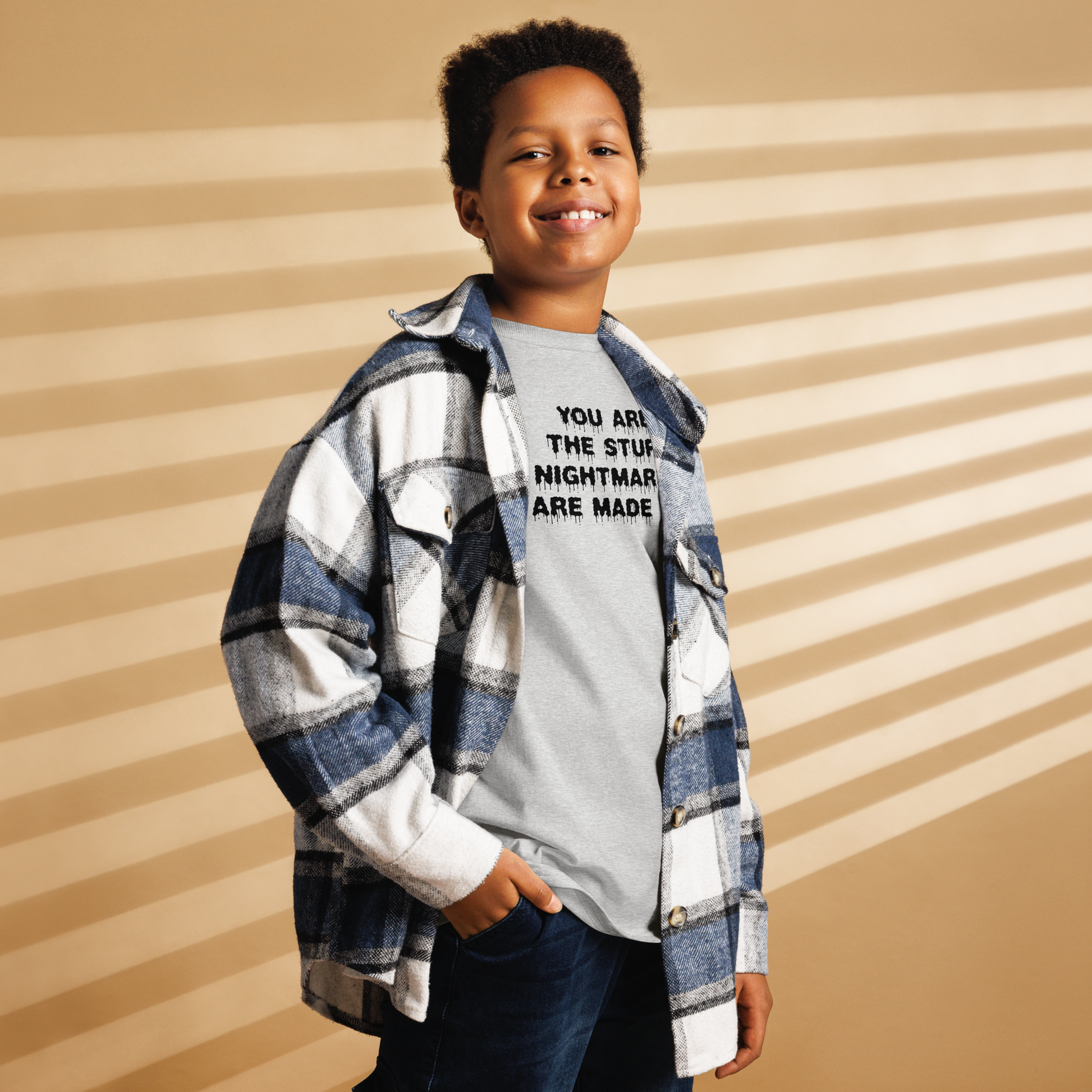 "You are the stuff nightmares are made of" printed on a sport grey youth classic tee worn by a male also wearing a jacket