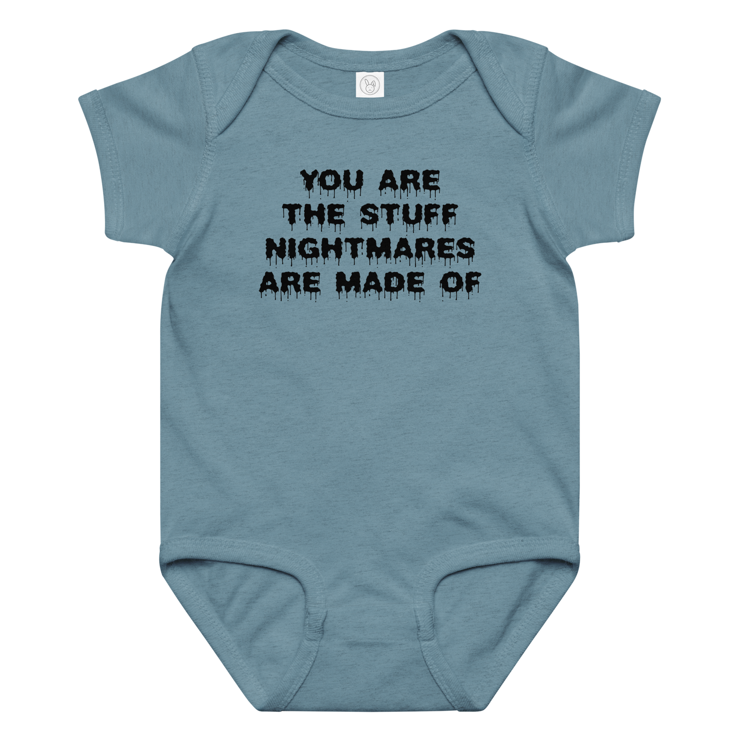 "You are the stuff nightmares are made of" printed on a vintage indigo baby jersey bodysuit laying on a flat surface amongst other clothes