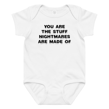 "You are the stuff nightmares are made of" printed on a white baby jersey bodysuit laying on a flat surface amongst other clothes