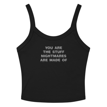 "You are the stuff nightmares are made of" printed on a solid black blend women's micro-rib tanktop laying on a flat surface amongst sunglasses and shorts
