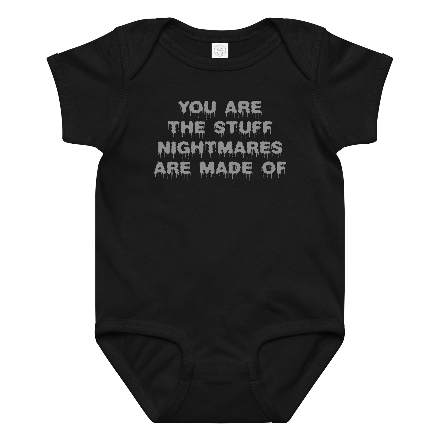 "You are the stuff nightmares are made of" printed on a black baby jersey bodysuit laying on a flat surface amongst other clothes
