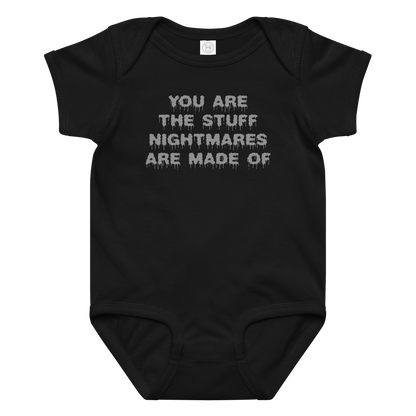 "You are the stuff nightmares are made of" printed on a black baby jersey bodysuit laying on a flat surface amongst other clothes