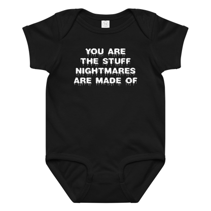 "You are the stuff nightmares are made of" printed on a black baby jersey bodysuit laying on a flat surface amongst other clothes