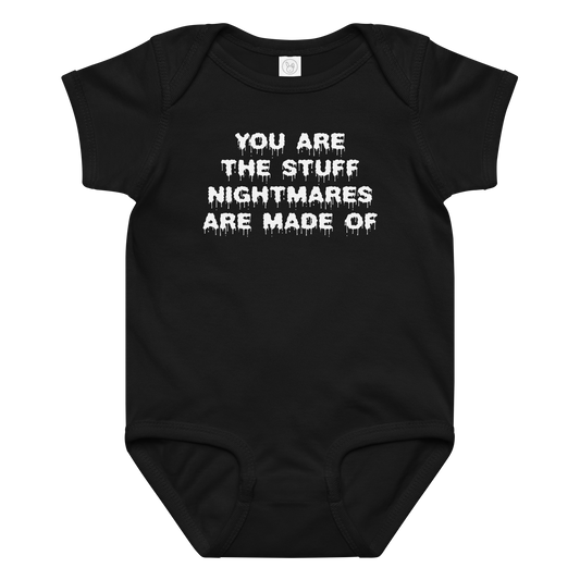 "You are the stuff nightmares are made of" printed on a black baby jersey bodysuit laying on a flat surface amongst other clothes