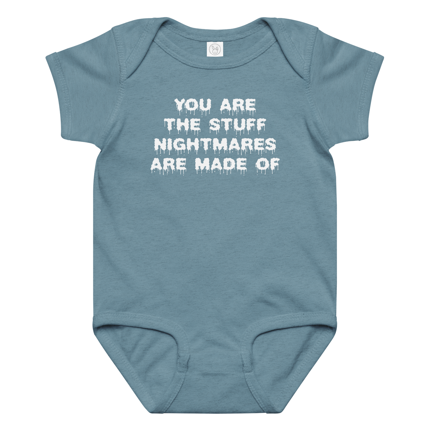 "You are the stuff nightmares are made of" printed on a vintage indigo baby jersey bodysuit laying on a flat surface amongst other clothes
