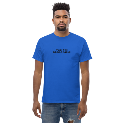 "You are remarkable" printed on a royal unisex classic tee worn by a male