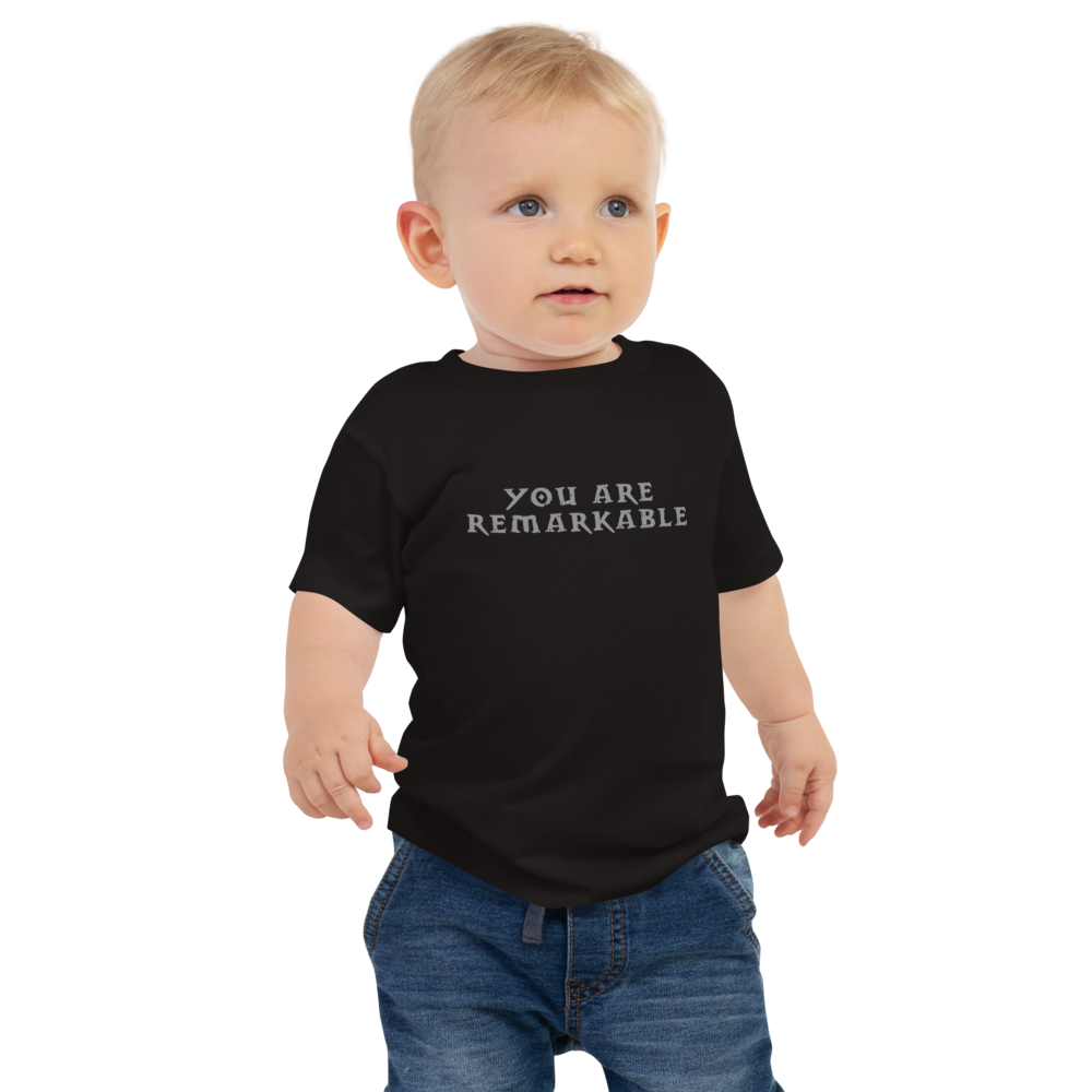 "You are remarkable" printed on a black baby jersey short sleeve tee worn by a male