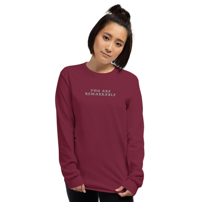 "You are remarkable" printed on a maroon men's long sleeve shirt worn by a female
