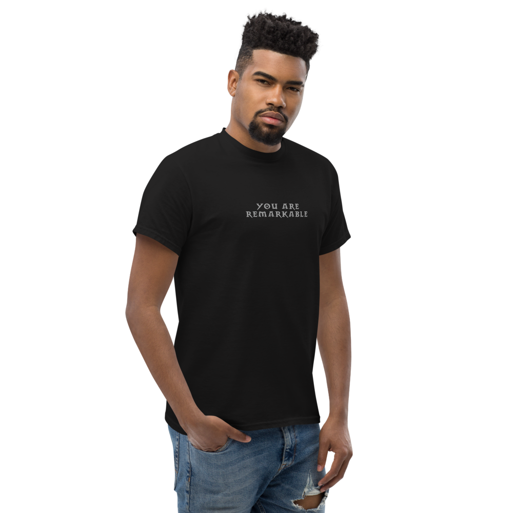"You are remarkable" printed on a black unisex classic tee worn by a male