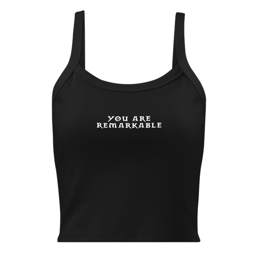 "You are remarkable" printed on a solid black blend women's micro-rib tanktop laying on a flat surface
