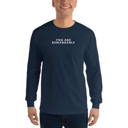 "You are remarkable" printed on a navy men's long sleeve shirt worn by a male