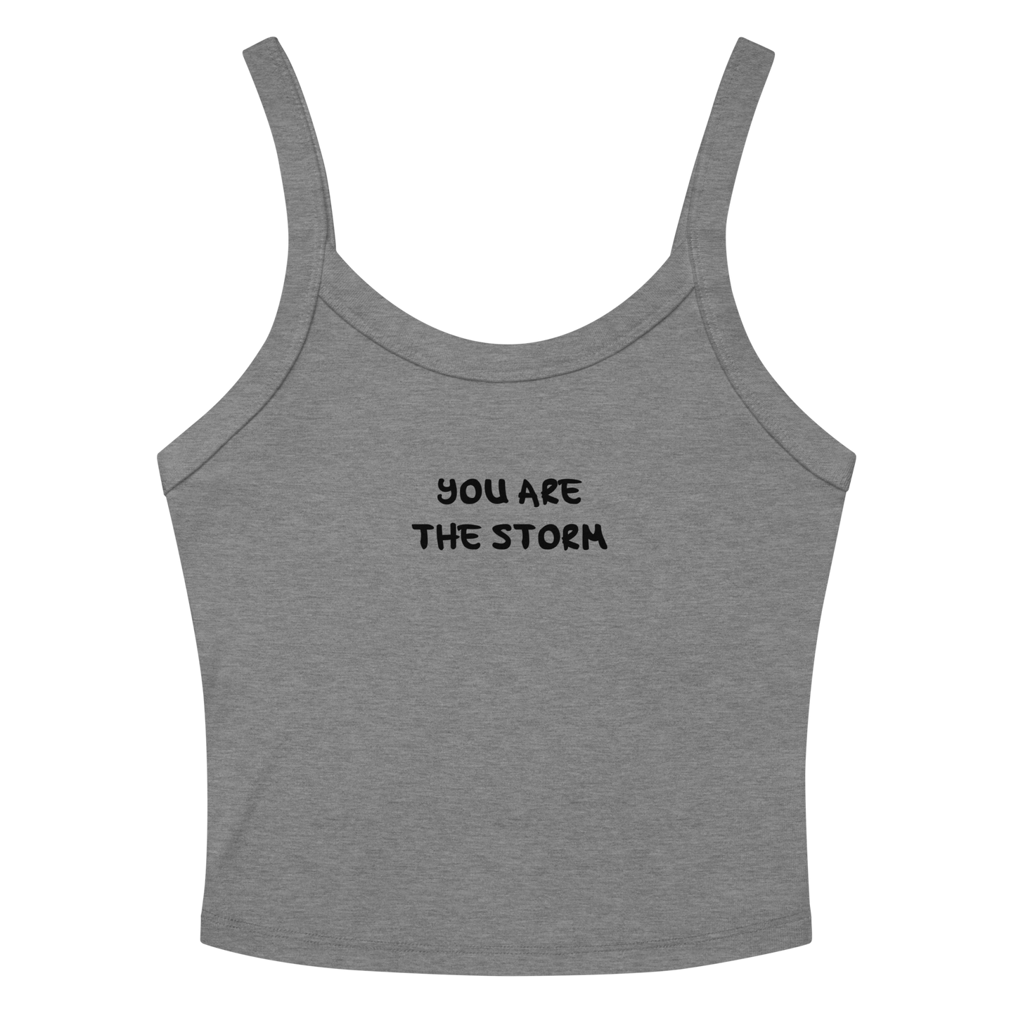 "You are the storm" printed on a athletic heather women's micro-rib tanktop laying on a flat surface amongst sunglasses and shorts