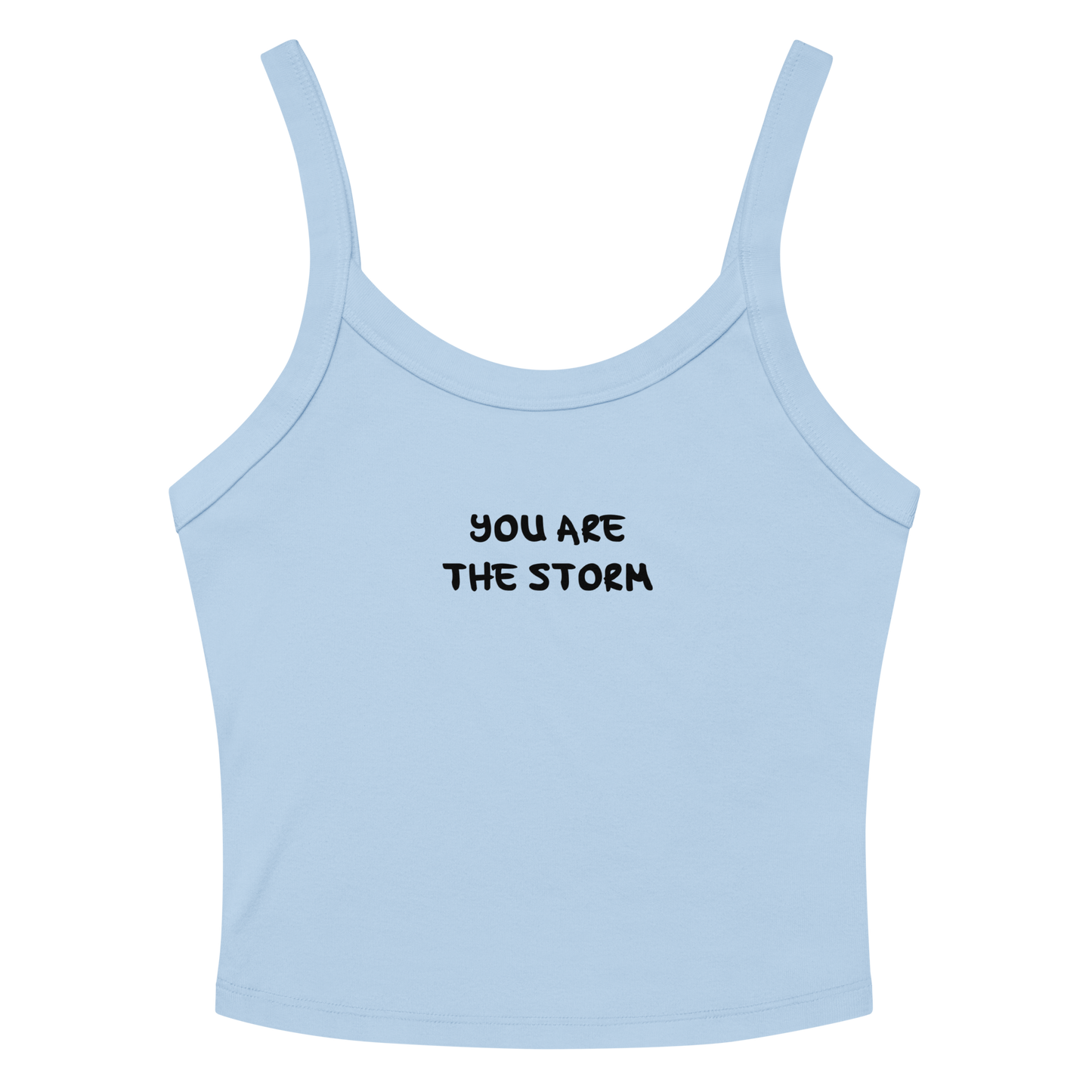 "You are the storm" printed on a solid baby blue blend women's micro-rib tanktop laying on a flat surface amongst sunglasses and shorts