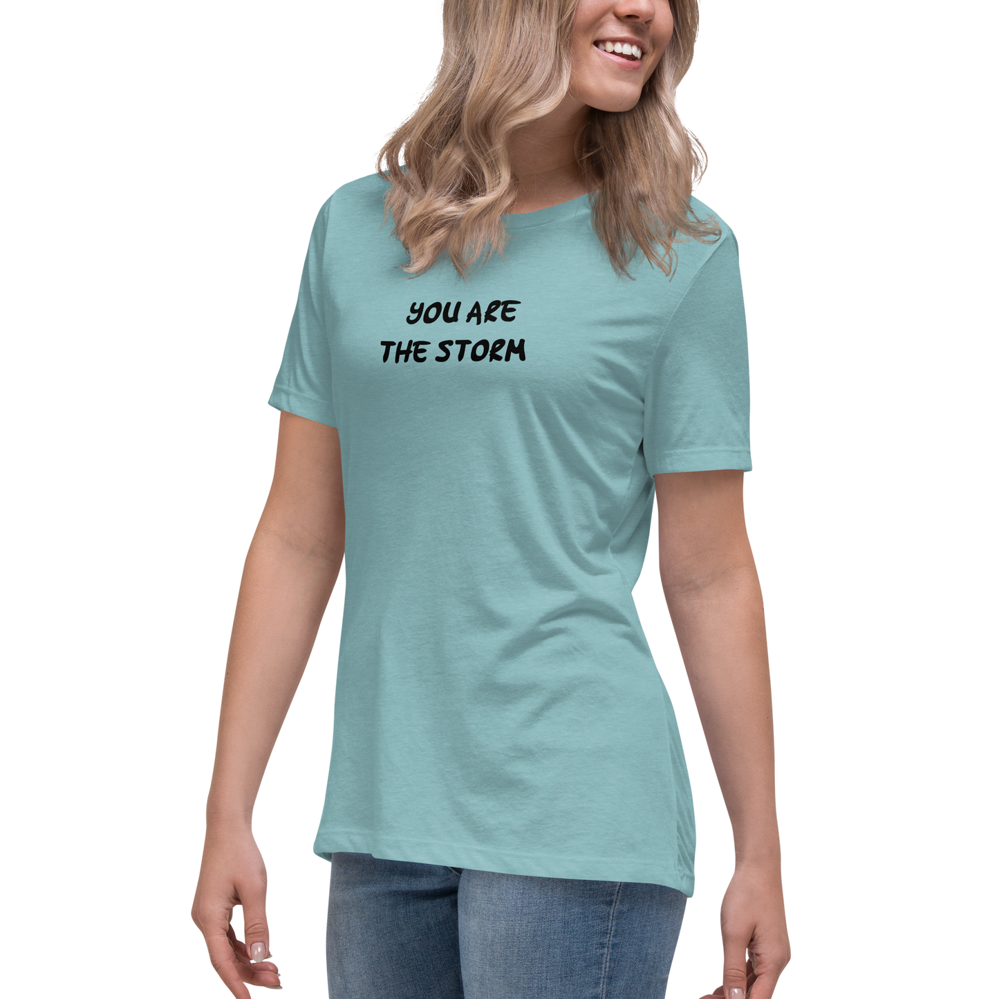 "You are the storm" printed on a heather blue lagoon women's relaxed t-shirt worn by a female