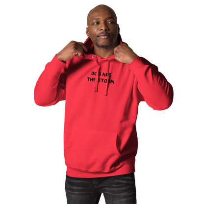 "You are the storm" printed on a team red unisex hoodie worn by a male