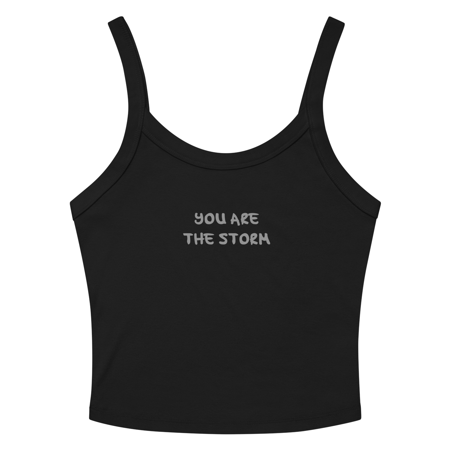 "You are the storm" printed on a solid black blend women's micro-rib tanktop laying on a flat surface amongst sunglasses and shorts