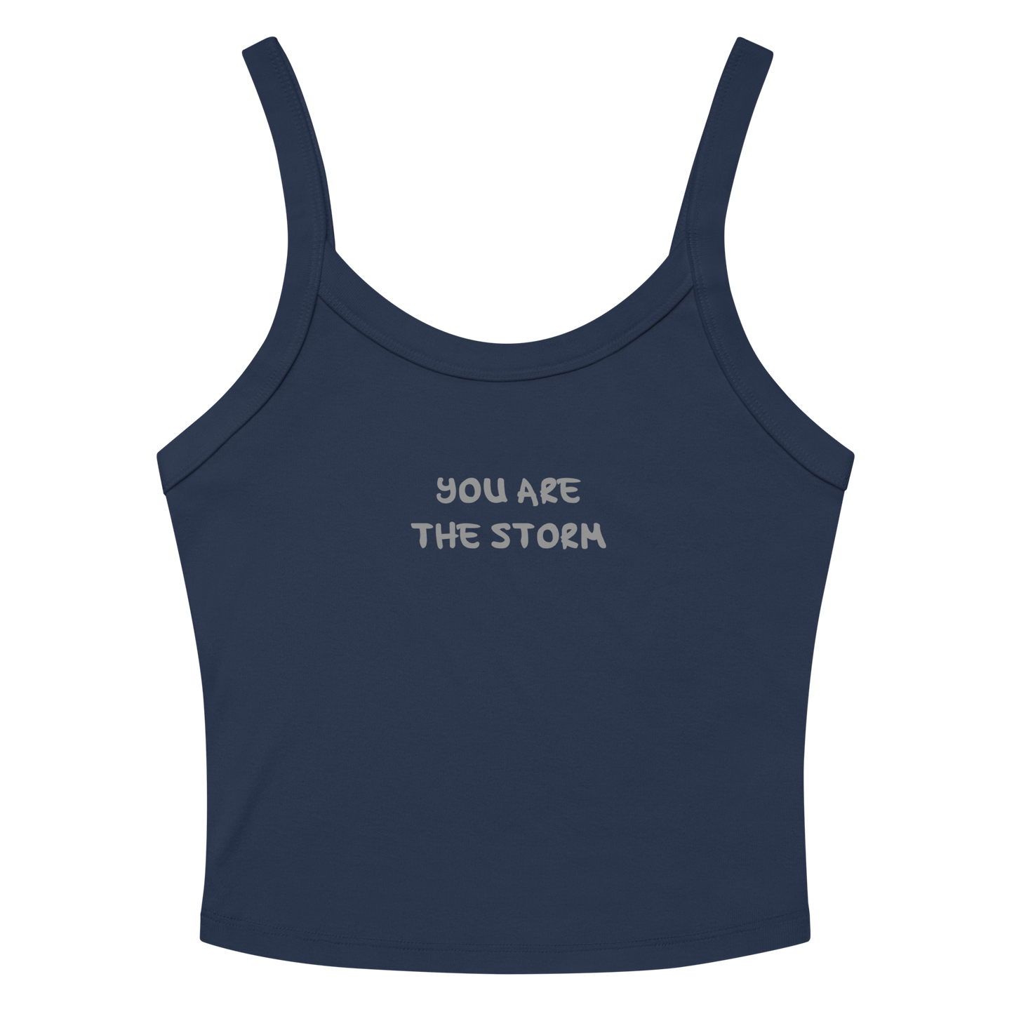 "You are the storm" printed on a solid navy blend women's micro-rib tanktop laying on a flat surface amongst sunglasses and shorts