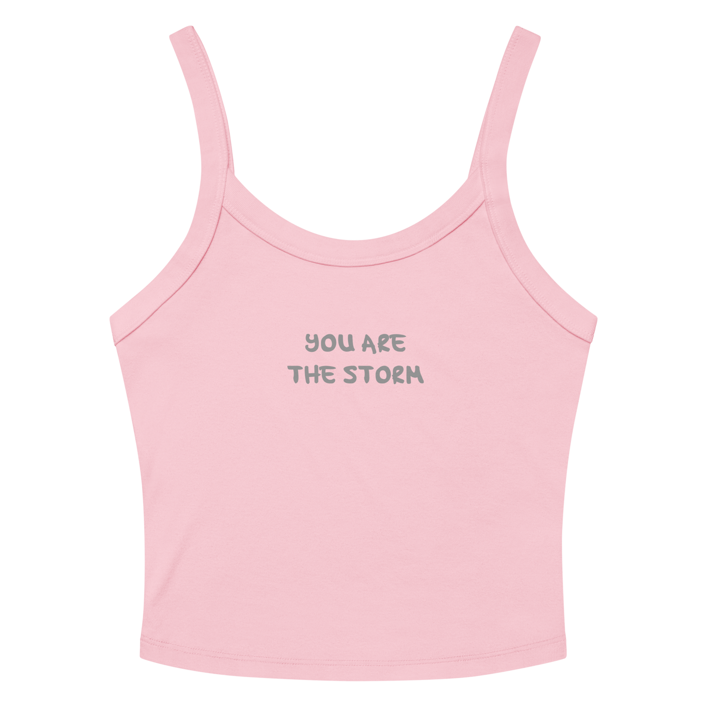 "You are the storm" printed on a solid pink blend women's micro-rib tanktop laying on a flat surface amongst sunglasses and shorts