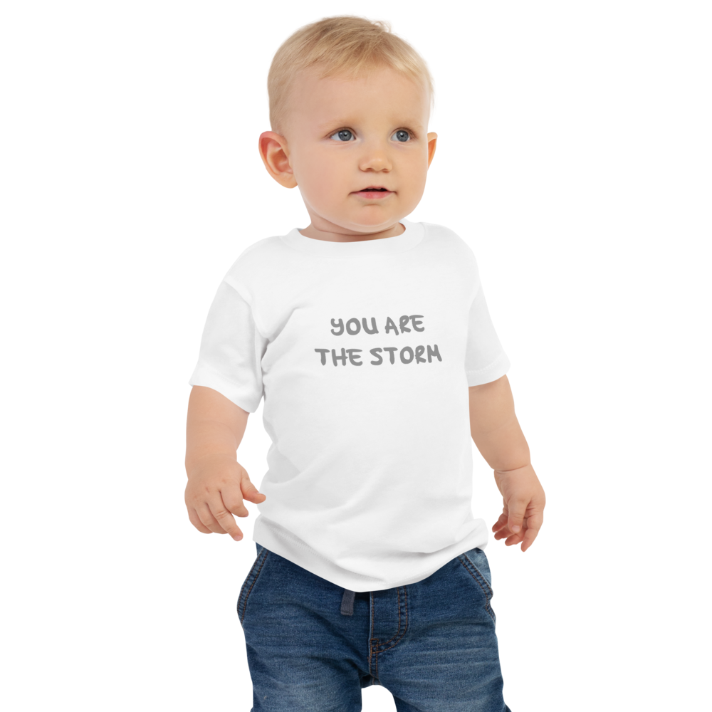 "You are the storm" printed on a white baby jersey short sleeve tee worn by a male
