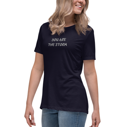 "You are the storm" printed on a navy women's relaxed t-shirt worn by a female