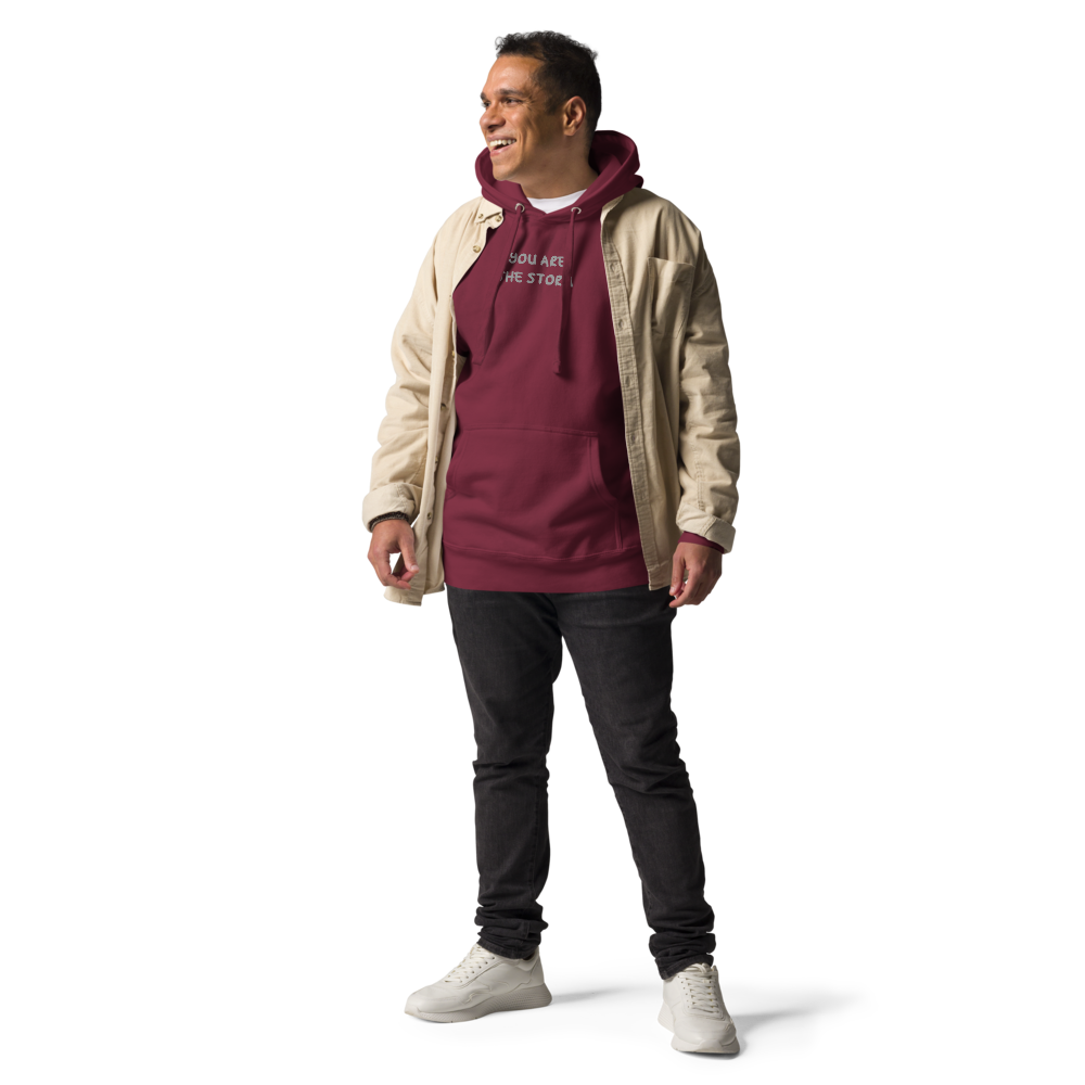 "You are the storm" printed on a maroon unisex hoodie worn by a male with a jacket on top