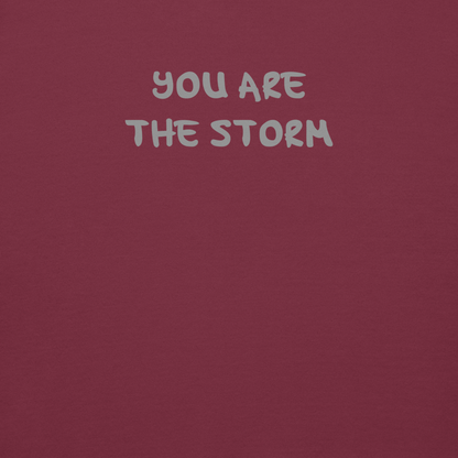 "You are the storm" printed on a maroon background