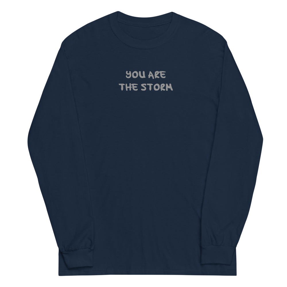 "You are the storm" printed on a navy men's long sleeve shirt laying on a flat surface