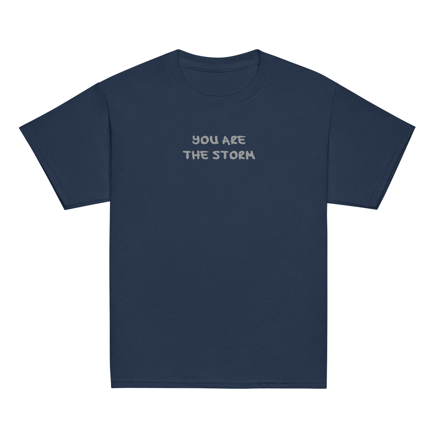 "You are the storm" printed on a navy youth classic tee laying on a flat surface