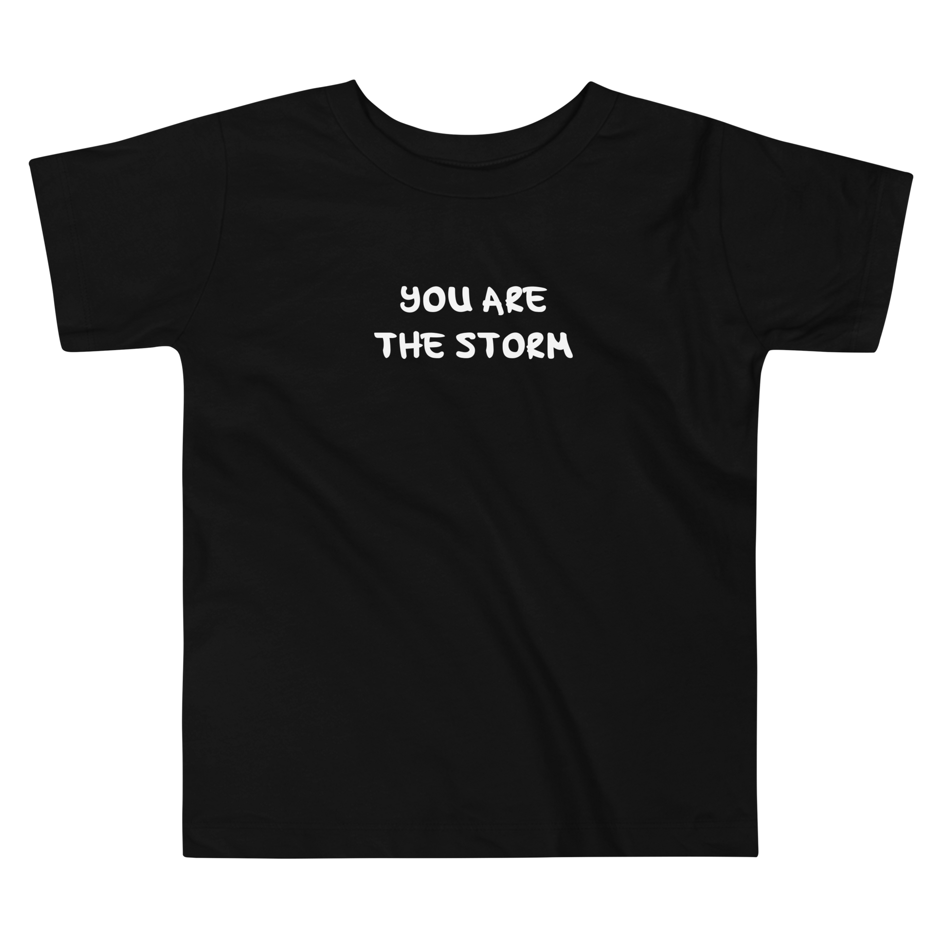 "You are the storm" printed on a black toddler short sleeve tee laying on a flat surface