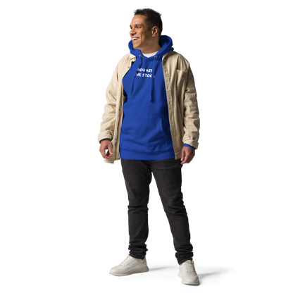 "You are the storm" printed on a team royal unisex hoodie worn by a male with a jacket on top