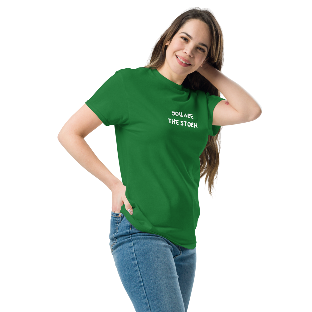 "You are the storm" printed on a turf green unisex classic tee worn by a female