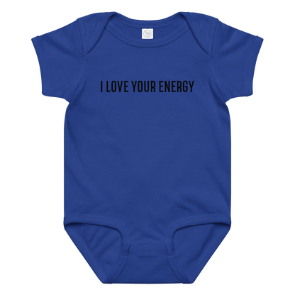 "I love your energy" printed on a royal baby jersey bodysuit laying on a flat surface amongst other clothes