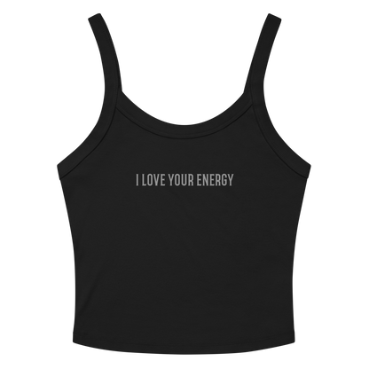 "I love your energy" printed on a solid black blend women's micro-rib tanktop laying on a flat surface amongst sunglasses and shorts