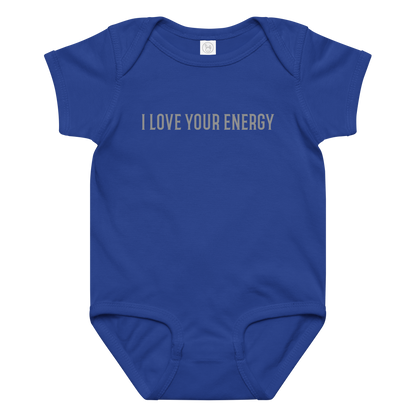 "I love your energy" printed on a royal baby jersey bodysuit laying on a flat surface amongst other clothes