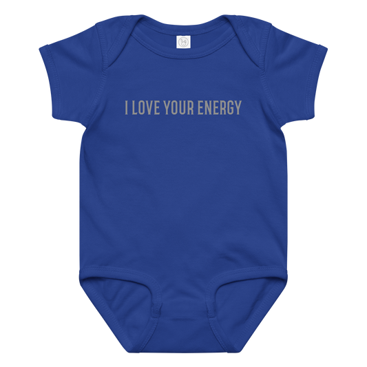 "I love your energy" printed on a royal baby jersey bodysuit laying on a flat surface amongst other clothes